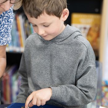 Boy looking at heritage documents