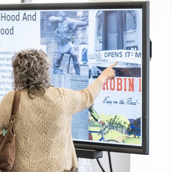 Person (from behind) touching points on an interactive map of Nottinghamshire