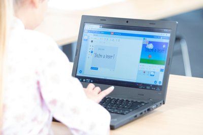 Child using laptop for coding