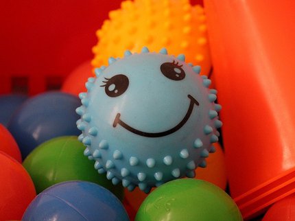 sensory toys, an assortment of balls including a blue spikey one with a smiley face