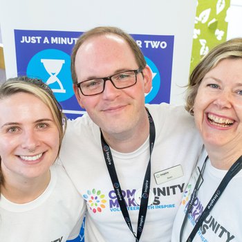 Three people wearing community makers tshirts smiling to the camera