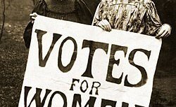 Black and white photo of two women holding a sign reading 'Votes for Women'