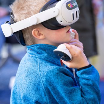 A boy wearing a virtual reality headset.